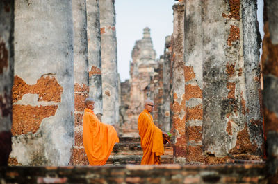 Monks wearing traditional clothing standing at temple