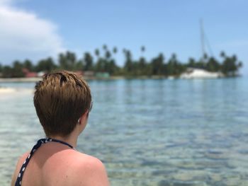 Rear view of boy in sea