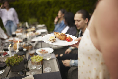 Person holding food on plate