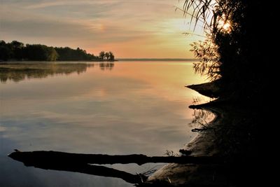 Scenic view of lake against sky during sunset