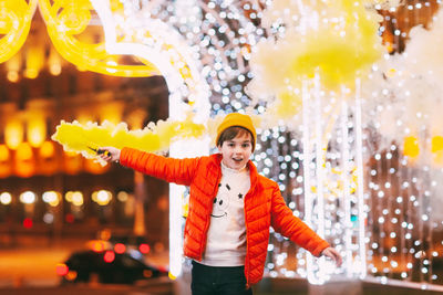 A teenage boy with a smoke bomb in his hands during the celebration of christmas 