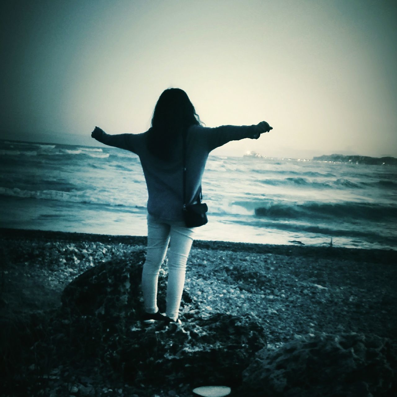 sea, beach, horizon over water, full length, real people, standing, sunset, sand, lifestyles, water, one person, beauty in nature, outdoors, clear sky, wave, nature, scenics, sky, young adult, adult, people, day