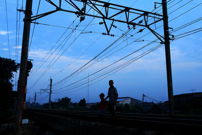 Low angle view of electricity pylon against sky