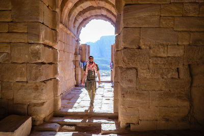 Woman standing on stone wall