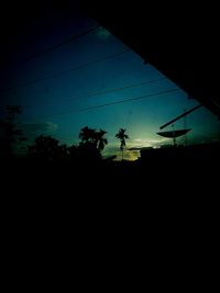 Low angle view of power lines against sky