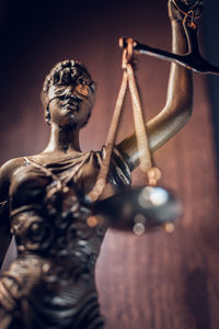 Detail of lady justice statue with scales and blindfold