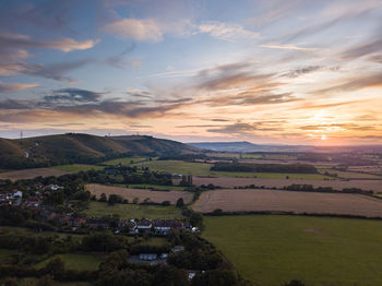 Scenic view of field against sky during sunset