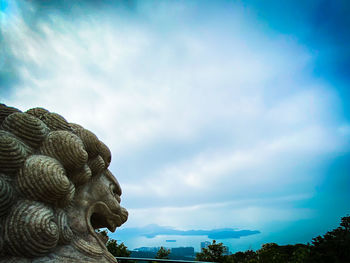 Low angle view of statue against blue sky