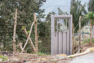 Closed wooden gate on field