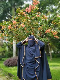 Rear view of two people standing in park