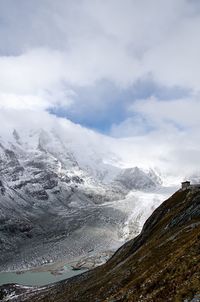 View of snowcapped mountain against cloudy sky