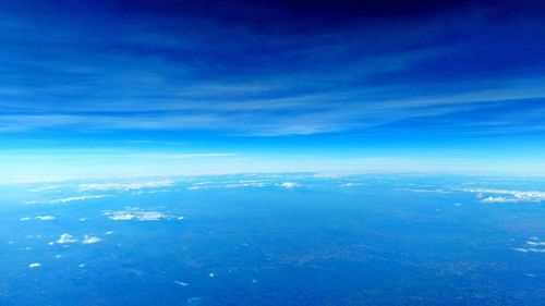 Aerial view of sea against blue sky