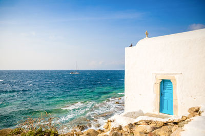 Building by sea against sky