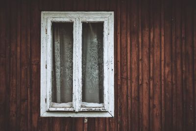 Close-up of snow on window of house