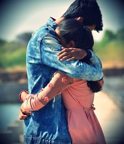 Rear view of couple holding hands