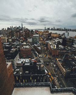 Cityscape against cloudy sky