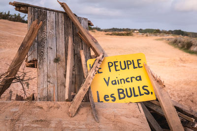 Information sign on wood against sky