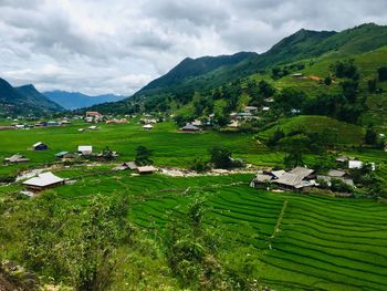 Scenic view of field and mountains against sky