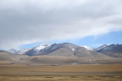 Scenic view of landscape and mountains against sky