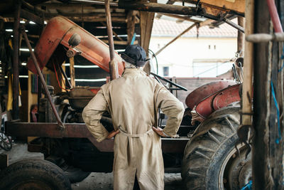 Back view of olf excavator driver in uniform