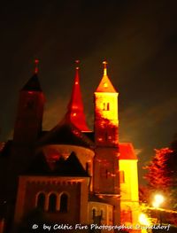 Illuminated building against sky at night