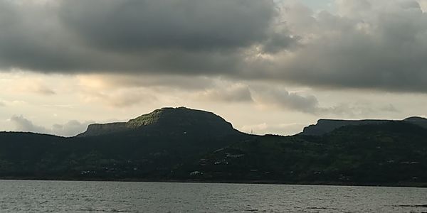 Scenic view of sea and mountains against sky