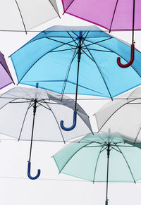 Low angle view of umbrella against blue sky