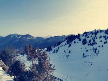 Scenic view of snow covered mountains against sky