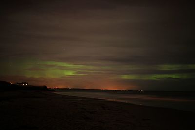 Scenic view of beach against sky at night