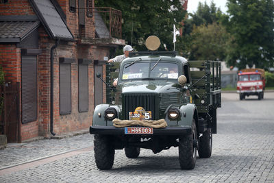 Cars on street by buildings in city