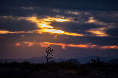 Silhouette landscape against sky during sunset