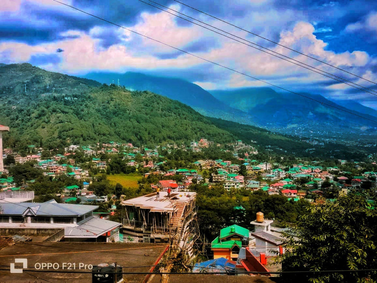 mountain, architecture, cloud, building exterior, nature, sky, built structure, building, town, plant, tree, city, landscape, house, environment, scenics - nature, mountain range, residential district, day, beauty in nature, transportation, outdoors, land, high angle view, no people, mode of transportation, travel destinations, village, travel, cityscape, cable