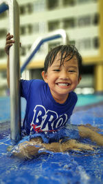 Portrait of smiling boy in swimming pool