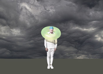 Digital composite image of person holding balloons