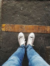 Low section of man standing on tiled floor