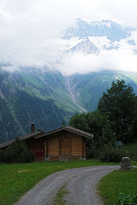 House by mountain against sky