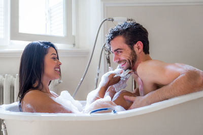 Portrait of happy friends in bathroom at home