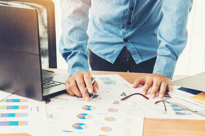 Close-up of businessman analyzing document in office