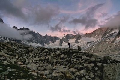 Panoramic shot of people on mountain against sky during sunset