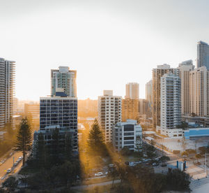 Buildings in city against clear sky