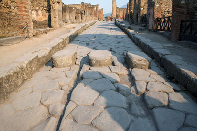 Cobblestone street amidst old buildings in city