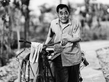 Portrait of senior man with bicycle