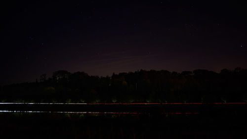 Scenic view of landscape against sky at night