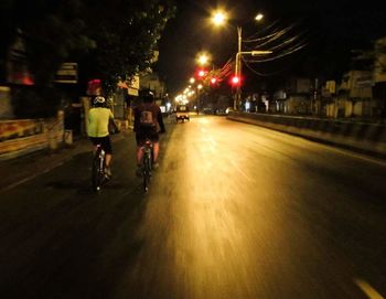 Woman walking on road at night