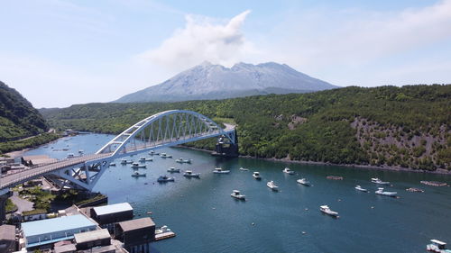 Scenic view of bridge over mountains against sky