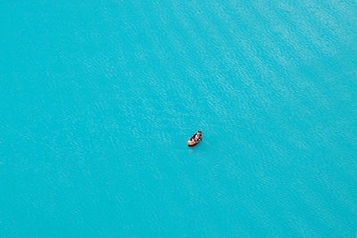 High angle view of boat floating on blue water