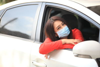 Portrait of woman sitting in car