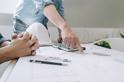 Low angle view of man working on table