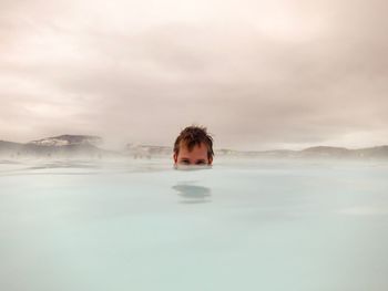 Portrait of boy swimming in pool