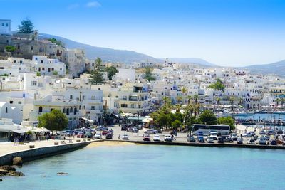 Sailboats in city at waterfront